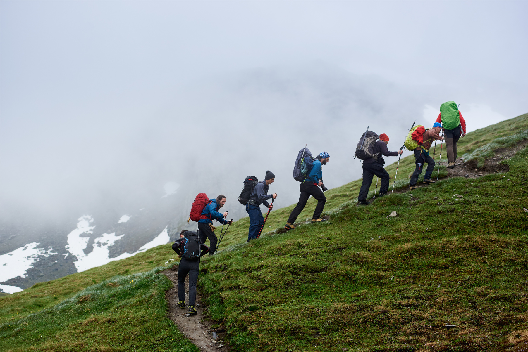 Group of travelers climbing the mountain.